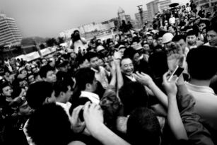 The premier of China, Wen Jiabao has become the face of the Chinese government during the catastrophe. "Grandpa" as he is called is here seen visiting a group of factory workers that survived the quake.